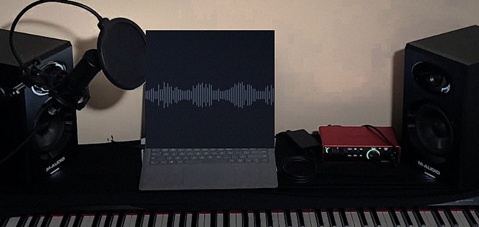 The studio: keyboard, microphone, monitors and a laptop